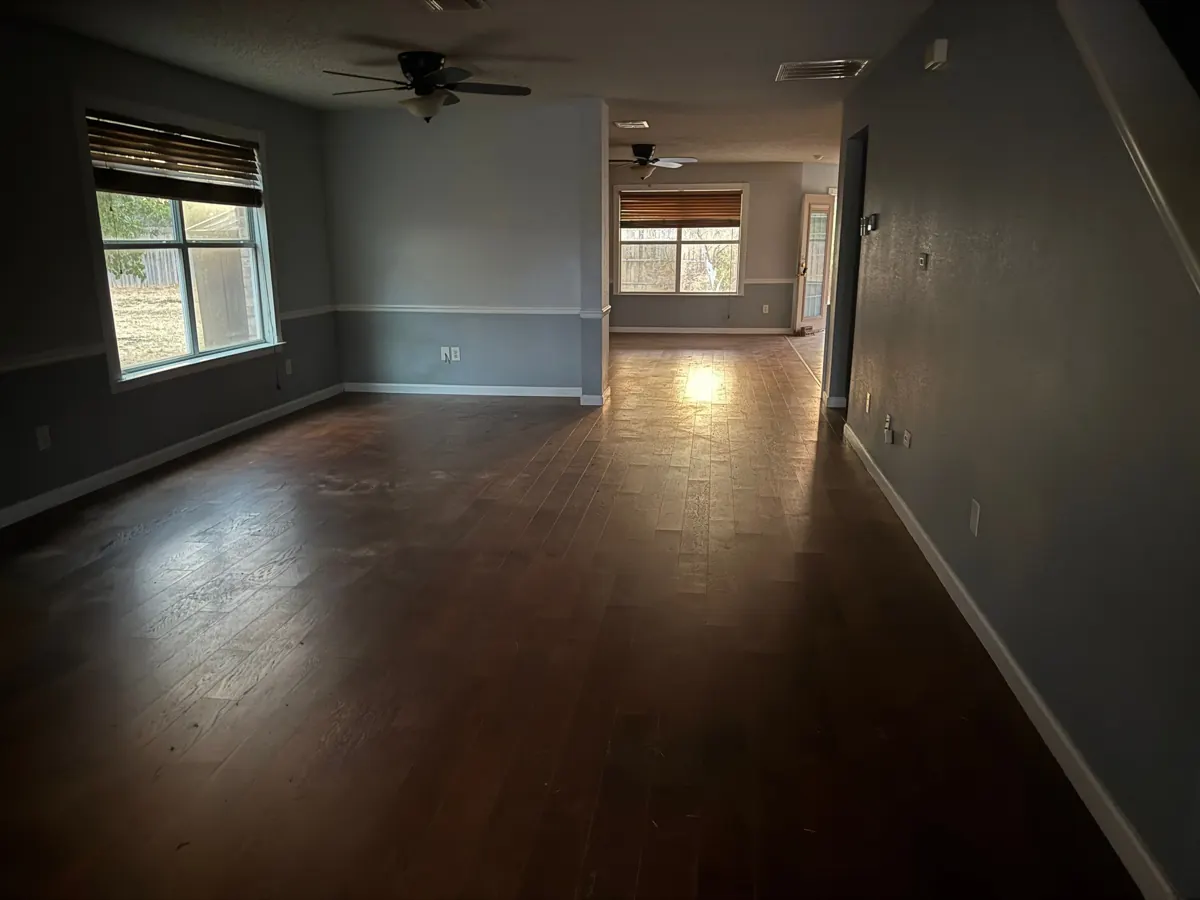 After: empty, swept front living area after the Hot Mess Haulin crew cleared it