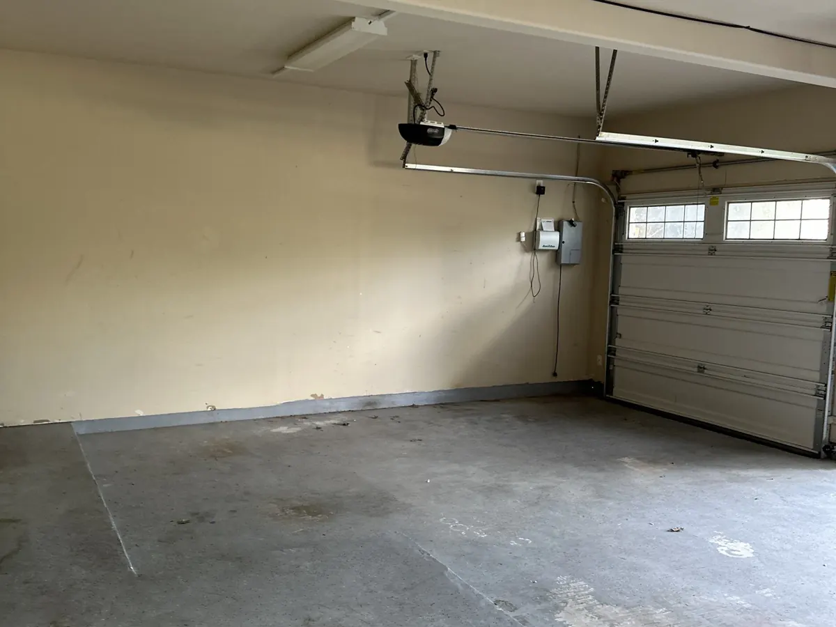 After: empty, swept two-car garage after the Hot Mess Haulin crew cleared it