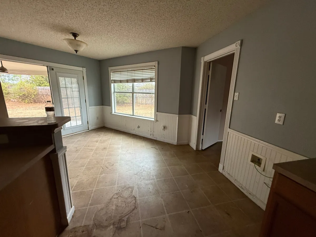 After: empty, swept kitchen breakfast nook after the Hot Mess Haulin crew cleared it